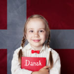 child girl student with book against the danish flag background 1