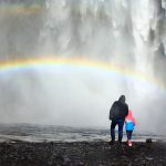 dad and kid are under the rainbow e1632464917649