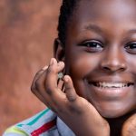 head shot of smiling nigerian girl e1620648647911