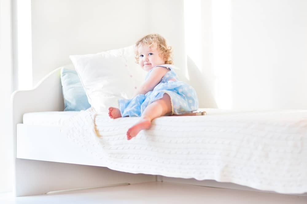 Niña sentada en la cama