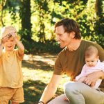 outdoor portrait of happy family having fun in summer park e1619419325502