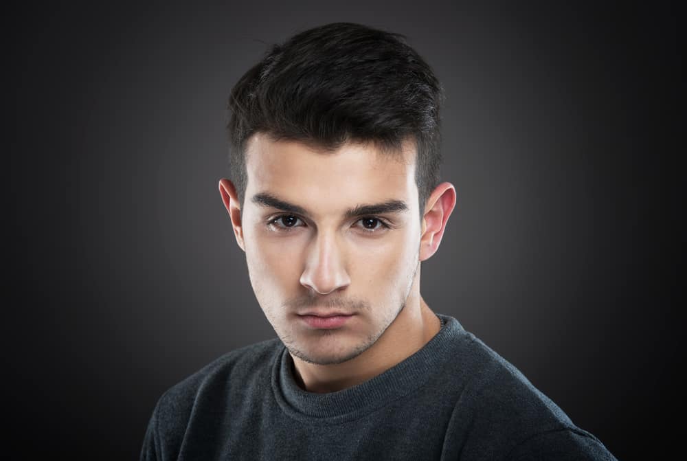 portrait of a serious young man looking at camera