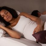 pregnant woman sleeping next to partner