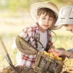 two boys found a treasure under a tree sunny summer day e1619076057711