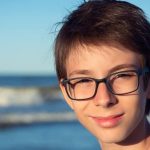 young boy posing at the summer beach e1619160125628